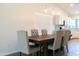 Dining area features a dark wooden table with six light-beige chairs at 2057 E Marquette Dr, Gilbert, AZ 85234