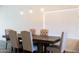 A Farmhouse style dining table with six upholstered chairs sits in front of a window at 2057 E Marquette Dr, Gilbert, AZ 85234