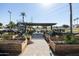 Community garden with raised planting beds and shaded seating area at 2057 E Marquette Dr, Gilbert, AZ 85234