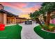 Landscaped backyard with a winding pathway leading to an outdoor entertaining area at 6802 E Paradise Pkwy, Scottsdale, AZ 85251