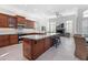 Spacious kitchen featuring island, wood cabinets, and stainless steel appliances at 12028 N 80Th Pl, Scottsdale, AZ 85260