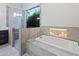Spa-like bathroom with soaking tub, walk-in shower, and modern fixtures at 12028 N 80Th Pl, Scottsdale, AZ 85260