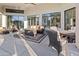 Relaxing covered patio with fire pit, seating area, and adjacent pool at 12028 N 80Th Pl, Scottsdale, AZ 85260