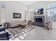 Living room with fireplace, large windows, and comfortable seating at 12028 N 80Th Pl, Scottsdale, AZ 85260