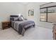 Comfortable bedroom with a queen-size bed and large window at 12028 N 80Th Pl, Scottsdale, AZ 85260