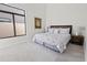 Spacious bedroom with king-size bed and large window at 12028 N 80Th Pl, Scottsdale, AZ 85260