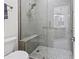 Clean shower with gray tile, built-in seat, and glass enclosure at 12028 N 80Th Pl, Scottsdale, AZ 85260