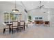 Open concept dining room with large windows and modern light fixture at 12028 N 80Th Pl, Scottsdale, AZ 85260