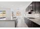 Modern kitchen featuring granite countertops and dark cabinets at 11856 W Lone Tree Trl, Peoria, AZ 85383