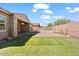Spacious backyard with a private pool and grassy area at 11856 W Lone Tree Trl, Peoria, AZ 85383
