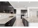 Modern kitchen with granite countertops and dark cabinetry at 11856 W Lone Tree Trl, Peoria, AZ 85383