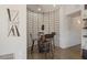 Small bar area with geometric wallpaper and dark wood bar stools at 2477 E Glenhaven Dr, Phoenix, AZ 85048