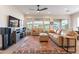 Living area features large windows, beige sofas, and a ceiling fan at 726 E Citrus Hollow Way, Queen Creek, AZ 85140