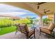 Covered patio with seating area, artificial turf, and built-in grill at 726 E Citrus Hollow Way, Queen Creek, AZ 85140
