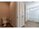 Clean bathroom with toilet and shower, plus storage at 726 E Citrus Hollow Way, Queen Creek, AZ 85140