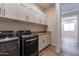 Laundry room with washer, dryer and cabinets at 726 E Citrus Hollow Way, Queen Creek, AZ 85140