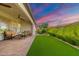 Relaxing backyard with artificial turf and covered patio at 726 E Citrus Hollow Way, Queen Creek, AZ 85140