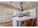 White kitchen with island, stainless steel appliances, and hardwood floors at 726 E Citrus Hollow Way, Queen Creek, AZ 85140