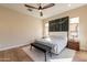 Bright bedroom featuring a king-size bed and wood floors at 726 E Citrus Hollow Way, Queen Creek, AZ 85140