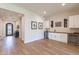Bright entryway with hardwood floors and a view into the wet bar at 726 E Citrus Hollow Way, Queen Creek, AZ 85140