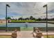Full-size tennis court with surrounding fence and landscaping at 726 E Citrus Hollow Way, Queen Creek, AZ 85140