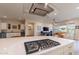 Modern kitchen island with gas cooktop and quartz countertop at 726 E Citrus Hollow Way, Queen Creek, AZ 85140