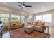 Tan leather sofas and ottomans in front of large windows at 726 E Citrus Hollow Way, Queen Creek, AZ 85140