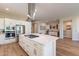 Modern kitchen with white cabinets, large island, and stainless steel appliances at 726 E Citrus Hollow Way, Queen Creek, AZ 85140