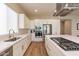 Modern kitchen with white cabinets, stainless steel appliances, and a large island at 726 E Citrus Hollow Way, Queen Creek, AZ 85140