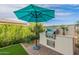 Built-in outdoor kitchen with grill and seating area at 726 E Citrus Hollow Way, Queen Creek, AZ 85140