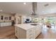 Open concept kitchen with white cabinets, a large island, and views to the Gathering room at 726 E Citrus Hollow Way, Queen Creek, AZ 85140