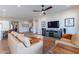 Spacious living room with light beige sofas and a large TV at 726 E Citrus Hollow Way, Queen Creek, AZ 85140