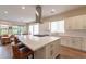 Modern kitchen with white cabinets and a large island at 726 E Citrus Hollow Way, Queen Creek, AZ 85140