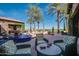 Outdoor patio furniture with a fountain and golf course view at 726 E Citrus Hollow Way, Queen Creek, AZ 85140