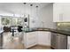 Modern kitchen with white cabinets, stainless steel appliances, and a large island at 7700 E Gainey Ranch Rd # 206, Scottsdale, AZ 85258