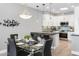 Bright dining area with a glass table and black chairs, adjacent to the kitchen at 7700 E Gainey Ranch Rd # 206, Scottsdale, AZ 85258