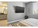 Bedroom with ensuite bathroom and wall-mounted TV at 7700 E Gainey Ranch Rd # 206, Scottsdale, AZ 85258