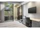 Bright bedroom with built-in workspace and access to a private balcony at 7700 E Gainey Ranch Rd # 206, Scottsdale, AZ 85258