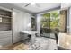 Bedroom with Murphy bed, built-in shelving, and access to balcony at 7700 E Gainey Ranch Rd # 206, Scottsdale, AZ 85258