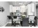 Modern dining area with glass table and black chairs near kitchen at 7700 E Gainey Ranch Rd # 206, Scottsdale, AZ 85258
