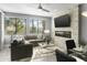 Living room with stone fireplace, large windows, and sectional sofa at 7700 E Gainey Ranch Rd # 206, Scottsdale, AZ 85258
