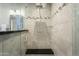 Walk-in shower with glass enclosure and tiled walls at 7700 E Gainey Ranch Rd # 206, Scottsdale, AZ 85258
