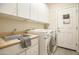 Laundry room with washer, dryer, and utility sink at 5222 W Buckskin Trl, Phoenix, AZ 85083