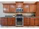 Modern kitchen with stainless steel appliances and granite countertops at 744 E Laddoos Ave, Queen Creek, AZ 85140