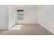 Simple bedroom with neutral carpeting and large window at 2268 S 162Nd Ln, Goodyear, AZ 85338
