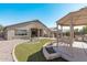 Landscaped backyard, featuring a gazebo and outdoor kitchen at 2268 S 162Nd Ln, Goodyear, AZ 85338