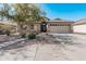 One-story house with tan exterior, stone accents, and a two-car garage at 2268 S 162Nd Ln, Goodyear, AZ 85338