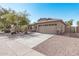 One-story house with tan exterior, stone accents, and a two-car garage at 2268 S 162Nd Ln, Goodyear, AZ 85338