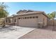One-story house with tan exterior, stone accents, and a two-car garage at 2268 S 162Nd Ln, Goodyear, AZ 85338