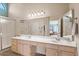 Bathroom with double sinks, vanity, and large mirror at 19132 N 95Th Ave, Peoria, AZ 85382